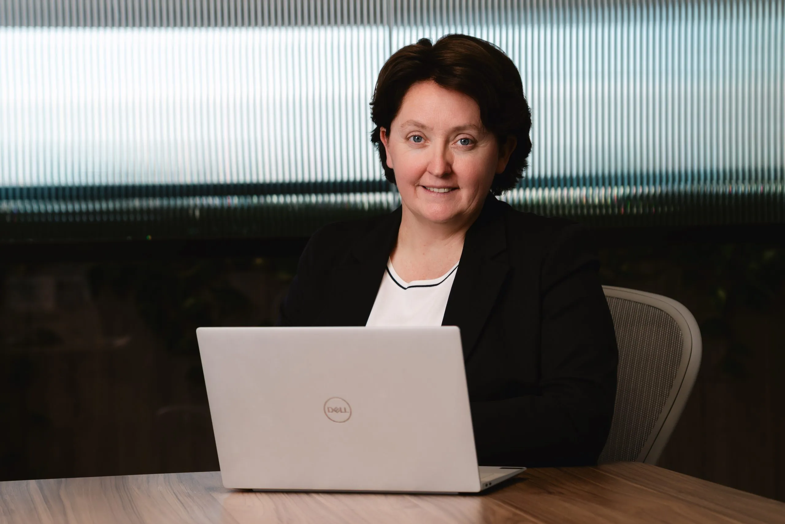 TMC consultant reviewing information on a laptop
